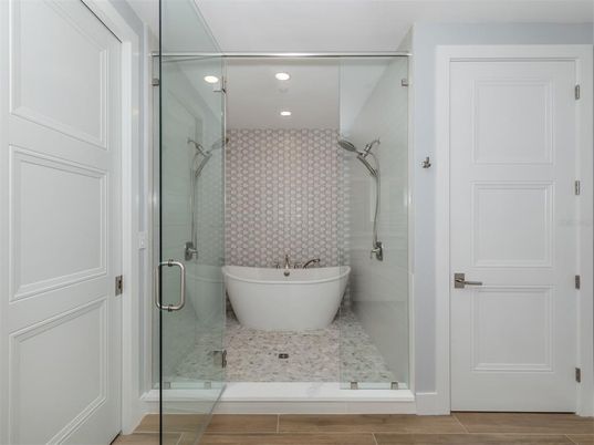 Bathroom, Free Standing Baths, Glass Shower, Interior, Recessed Lighting, Wood Texture Flooring