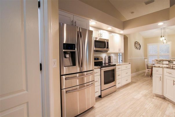 Interior, Kitchen, Wood Texture Flooring, Recessed Lighting, Chandelier, Stainless Steel Appliances, Pendant Lights