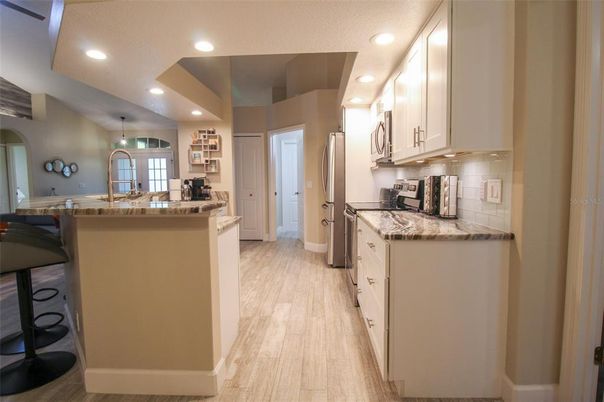 Interior, Kitchen, Wood Texture Flooring, Recessed Lighting, Dining room, Stainless Steel Appliances, Pendant Lights