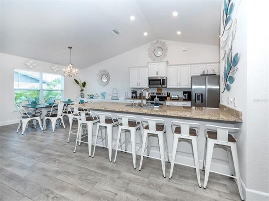 Chandelier, Dining room, Interior, Kitchen, Pendant Lights, Recessed Lighting, Stainless Steel Appliances, Wood Texture Flooring