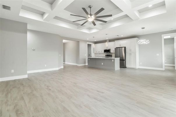Empty room, Interior, Kitchen, Pendant Lights, Recessed Lighting, Stainless Steel Appliances, Wood Texture Flooring