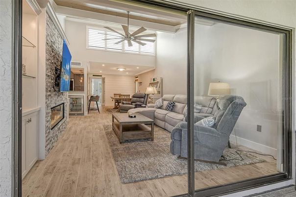 Dining room, Fireplace, Interior, Living room, Recessed Lighting, Stone Walls, Wood Texture Flooring