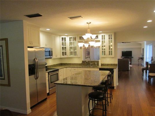 Chandelier, Interior, Kitchen, Living room, Recessed Lighting, Stainless Steel Appliances, Wood Texture Flooring