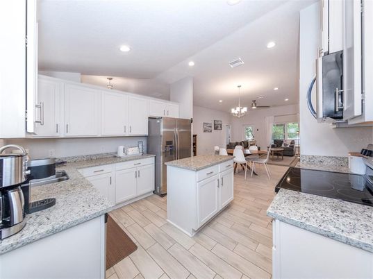 Chandelier, Dining room, Interior, Kitchen, Pendant Lights, Recessed Lighting, Stainless Steel Appliances, Wood Texture Flooring