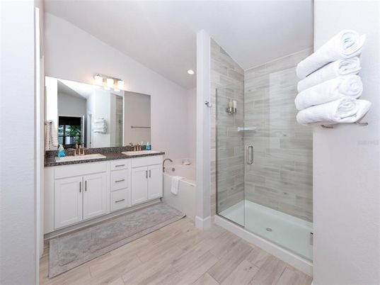 Bathroom, Dual Sink Vanities, Glass Shower, Interior, Recessed Lighting, Wood Texture Flooring