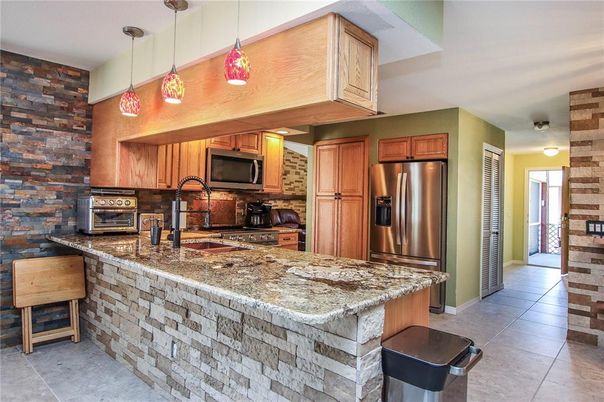 Interior, Kitchen, Pendant Lights, Stainless Steel Appliances, Stone Walls