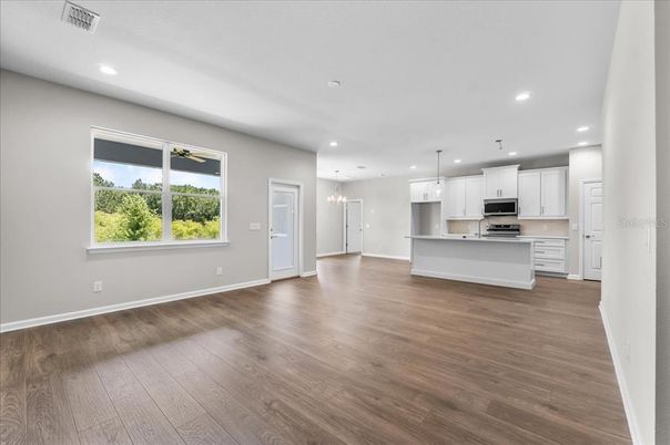 Empty room, Interior, Kitchen, Pendant Lights, Recessed Lighting, Stainless Steel Appliances, Wood Texture Flooring