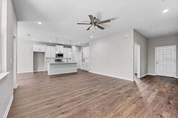 Empty room, Interior, Kitchen, Pendant Lights, Recessed Lighting, Stainless Steel Appliances, Wood Texture Flooring