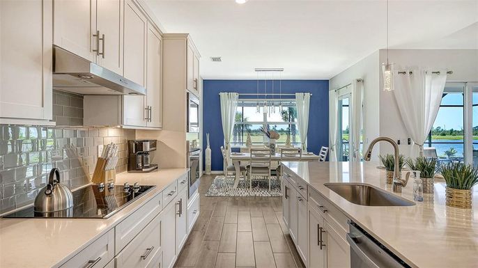 Dining room, Interior, Kitchen, Pendant Lights, Recessed Lighting, Stainless Steel Appliances, Water, Wood Texture Flooring
