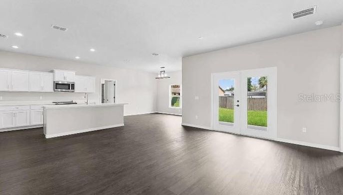Empty room, Interior, Kitchen, Pendant Lights, Recessed Lighting, Stainless Steel Appliances, Wood Texture Flooring