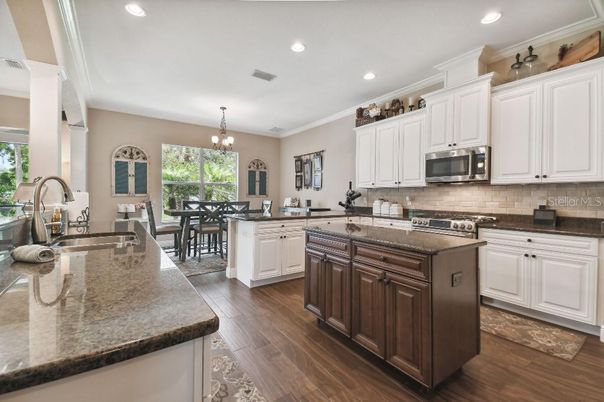 Chandelier, Dining room, Interior, Kitchen, Recessed Lighting, Stainless Steel Appliances, Wood Texture Flooring