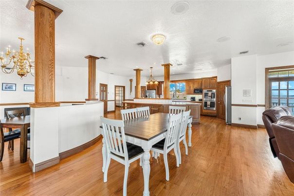 Chandelier, Dining room, Interior, Kitchen, Pendant Lights, Stainless Steel Appliances, Wood Texture Flooring