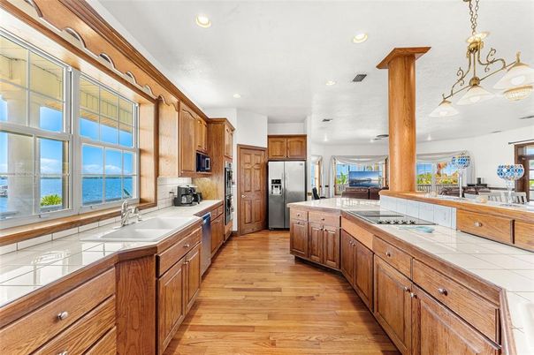 Interior, Kitchen, Pendant Lights, Recessed Lighting, Stainless Steel Appliances, Tile Countertops, Wood Texture Flooring