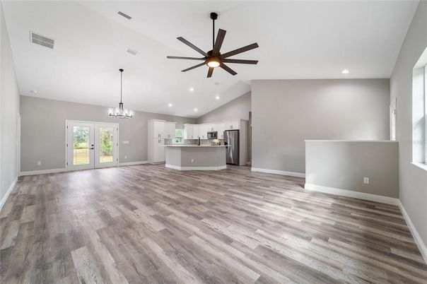 Chandelier, Empty room, Interior, Kitchen, Pendant Lights, Recessed Lighting, Stainless Steel Appliances, Wood Texture Flooring