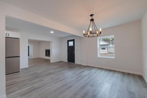 Chandelier, Empty room, Fireplace, Interior, Recessed Lighting, Wood Texture Flooring