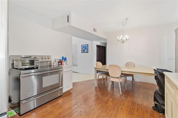 Chandelier, Dining room, Interior, Kitchen, Stainless Steel Appliances, Wood Texture Flooring
