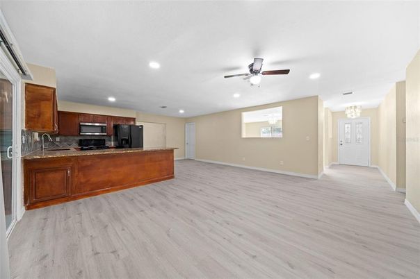 Chandelier, Empty room, Interior, Kitchen, Recessed Lighting, Stainless Steel Appliances, Wood Texture Flooring