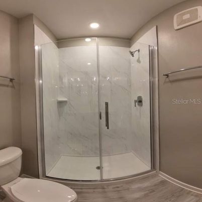 Bathroom, Glass Shower, Interior, Marble Walls, Recessed Lighting, Wood Texture Flooring