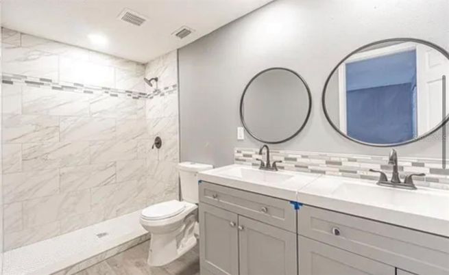 Bathroom, Dual Sink Vanities, Interior, Marble Walls, Recessed Lighting, Tile Countertops, Wood Texture Flooring