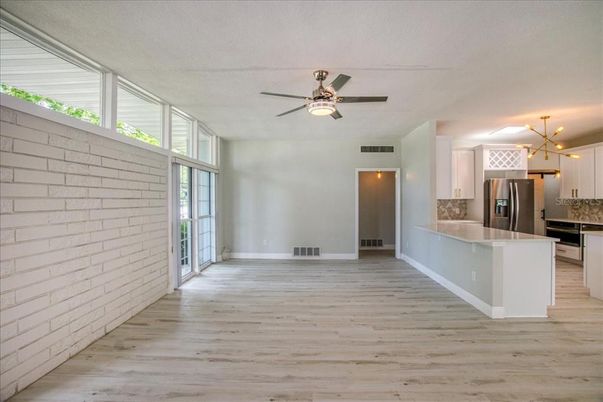 Empty room, Interior, Kitchen, Pendant Lights, Stainless Steel Appliances, Stone Walls, Wood Texture Flooring