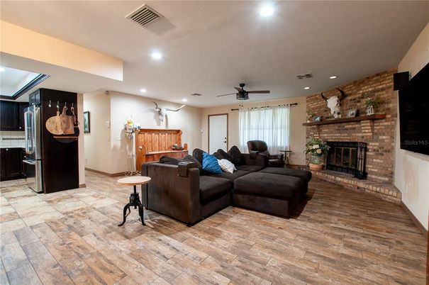 Fireplace, Interior, Living room, Recessed Lighting, Stone Walls, Wood Texture Flooring