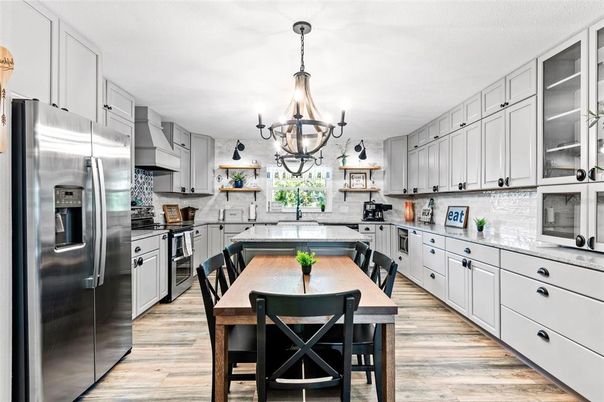 Chandelier, Dining room, Interior, Kitchen, Stainless Steel Appliances, Wood Texture Flooring