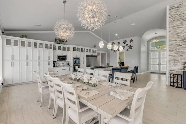 Chandelier, Dining room, Interior, Kitchen, Pendant Lights, Recessed Lighting, Stainless Steel Appliances, Wood Texture Flooring