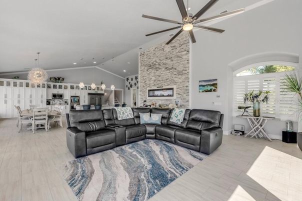 Chandelier, Dining room, Fireplace, Interior, Kitchen, Living room, Recessed Lighting, Stone Walls, Wood Texture Flooring
