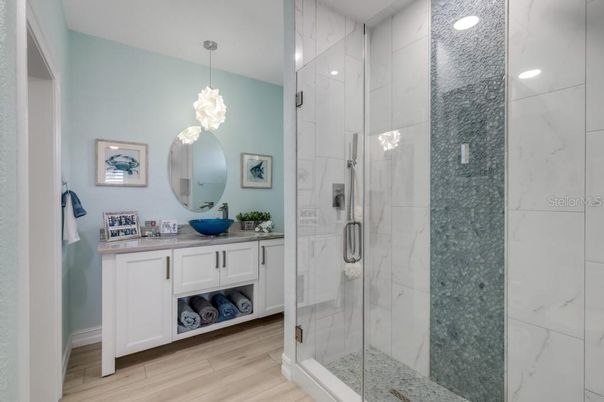 Bathroom, Glass Shower, Interior, Marble Walls, Pendant Lights, Recessed Lighting, Wood Texture Flooring
