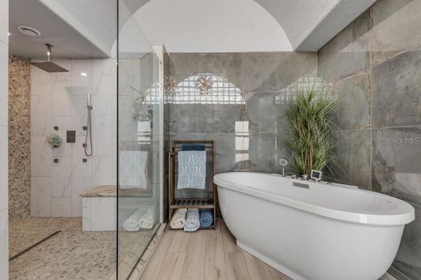 Bathroom, Free Standing Baths, Glass Shower, Interior, Marble Walls, Recessed Lighting, Wood Texture Flooring