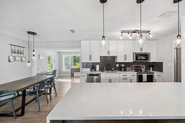 Dining room, Interior, Kitchen, Pendant Lights, Stainless Steel Appliances, Wood Texture Flooring