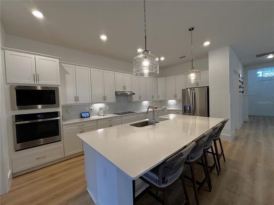 Interior, Kitchen, Pendant Lights, Recessed Lighting, Stainless Steel Appliances, Wood Texture Flooring