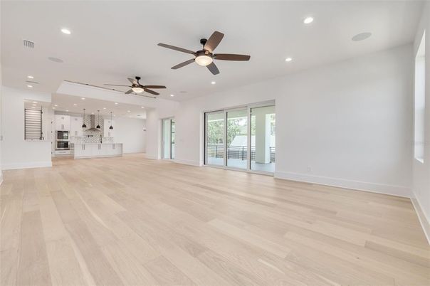 Empty room, Interior, Kitchen, Recessed Lighting, Stainless Steel Appliances, Wood Texture Flooring