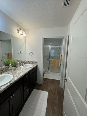 Bathroom, Dual Sink Vanities, Glass Shower, Interior, Wood Texture Flooring
