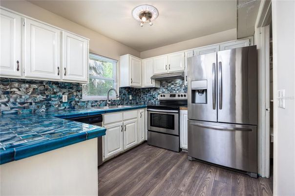 Interior, Kitchen, Stainless Steel Appliances, Tile Countertops, Wood Texture Flooring
