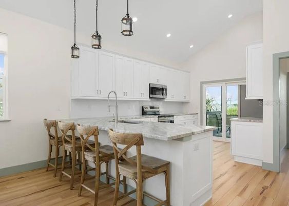 Dining room, Interior, Kitchen, Pendant Lights, Recessed Lighting, Stainless Steel Appliances, Wood Texture Flooring