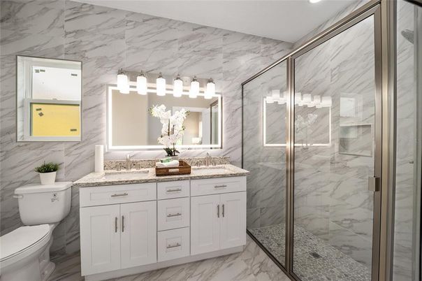 Bathroom, Dual Sink Vanities, Glass Shower, Interior, Marble, Marble Walls, Recessed Lighting
