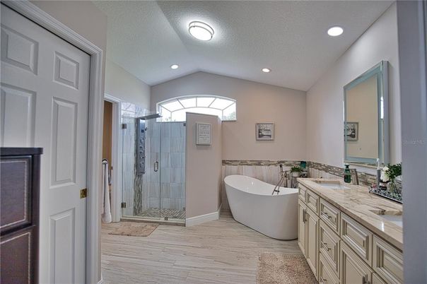 Bathroom, Dual Sink Vanities, Free Standing Baths, Glass Shower, Interior, Recessed Lighting, Wood Texture Flooring