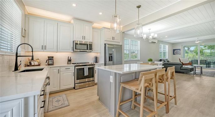 Chandelier, Interior, Kitchen, Living room, Pendant Lights, Recessed Lighting, Stainless Steel Appliances, Wood Texture Flooring