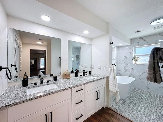 Bathroom, Dual Sink Vanities, Free Standing Baths, Interior, Marble Walls, Recessed Lighting, Wood Texture Flooring