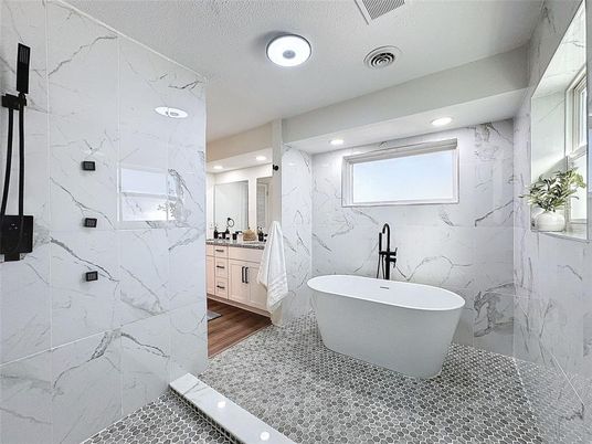 Bathroom, Free Standing Baths, Interior, Marble Walls, Recessed Lighting, Wood Texture Flooring