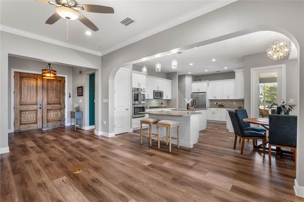 Chandelier, Dining room, Interior, Kitchen, Pendant Lights, Recessed Lighting, Stainless Steel Appliances, Wood Texture Flooring