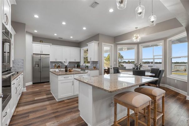 Chandelier, Dining room, Interior, Kitchen, Pendant Lights, Recessed Lighting, Stainless Steel Appliances, Wood Texture Flooring