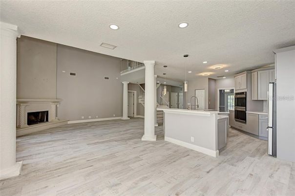 Fireplace, Interior, Kitchen, Pendant Lights, Recessed Lighting, Stainless Steel Appliances, Wood Texture Flooring