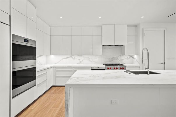 Interior, Kitchen, Marble Walls, Recessed Lighting, Stainless Steel Appliances, Wood Texture Flooring