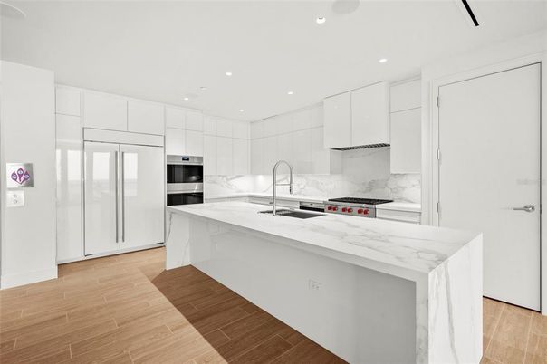 Interior, Kitchen, Marble Walls, Recessed Lighting, Stainless Steel Appliances, Wood Texture Flooring