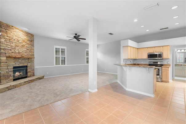 Empty room, Fireplace, Interior, Kitchen, Recessed Lighting, Stainless Steel Appliances, Stone Walls