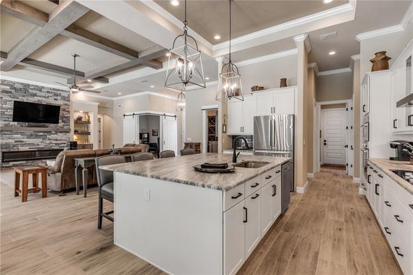 Fireplace, Interior, Kitchen, Living room, Pendant Lights, Recessed Lighting, Stainless Steel Appliances, Stone Walls, Wood Texture Flooring
