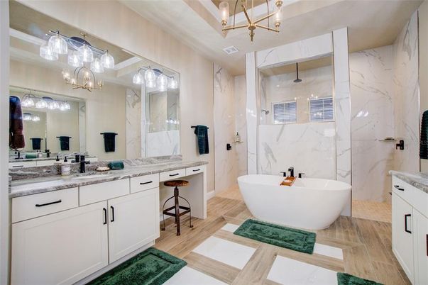 Bathroom, Chandelier, Dual Sink Vanities, Free Standing Baths, Interior, Marble Walls, Wood Texture Flooring