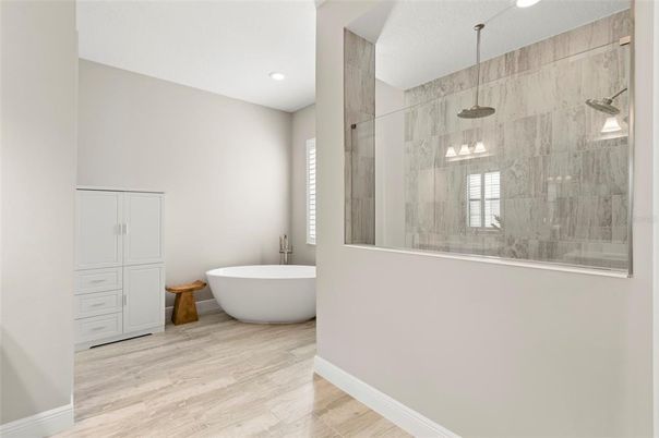Bathroom, Free Standing Baths, Glass Shower, Interior, Marble Walls, Pendant Lights, Recessed Lighting, Wood Texture Flooring